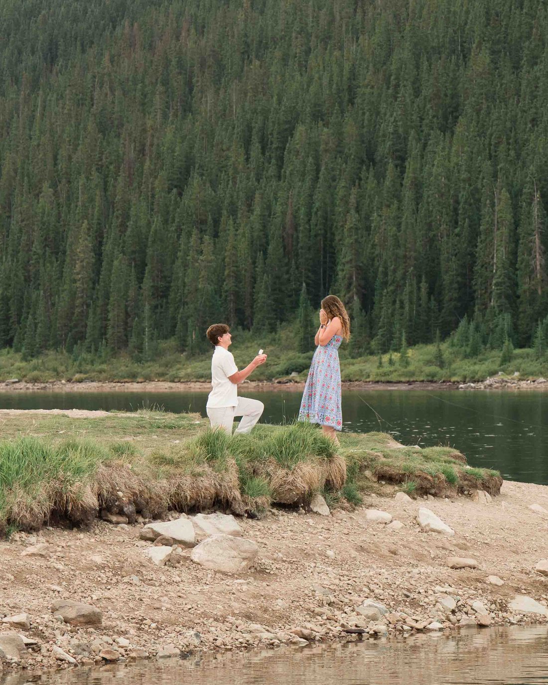 Brock on one knee by the lake