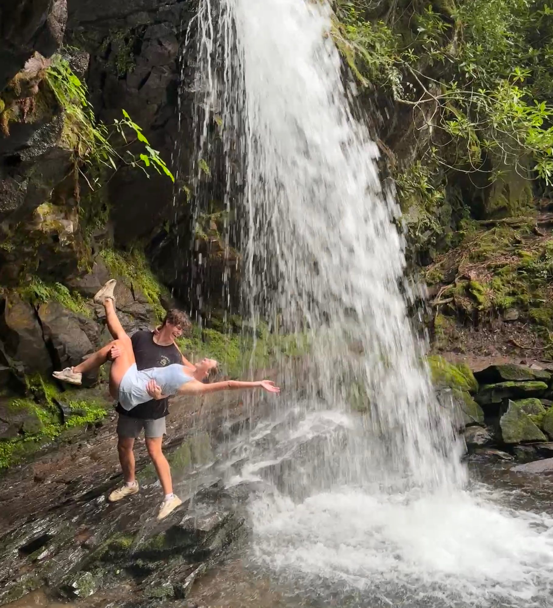 Brock holding Anna under a waterfall